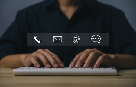 Businessman hand using laptop showing phone icon, email, address, live chat, on virtual screen. concept of Contacting us for a customer service center connection, communication on an Internet network.の写真素材