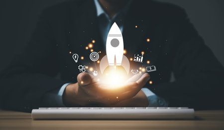 hand shows a rocket and an icon. Concept of Startup Business, Entrepreneurship Idea, and Online...