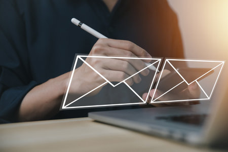 Businessman sending a letter from a computer. electronic mail concept is online communication on the Internet network Receiving and sending information or messages in digital technologyの写真素材