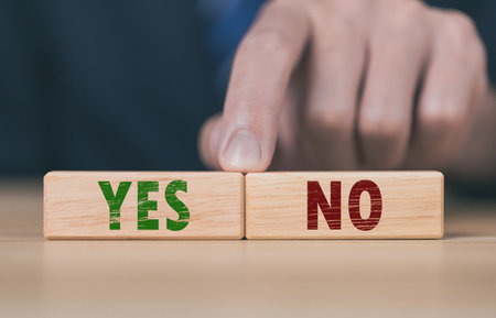 The wooden block shows yes or no letters. The concept of making decisions, voting, and thinking right and wrong. Business options for difficult situations true and false symbolの写真素材