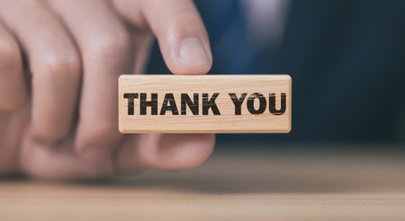 Businessman holding wooden block showing a message with word thank you letter writing ideas congratulations thank you copy spaceの写真素材