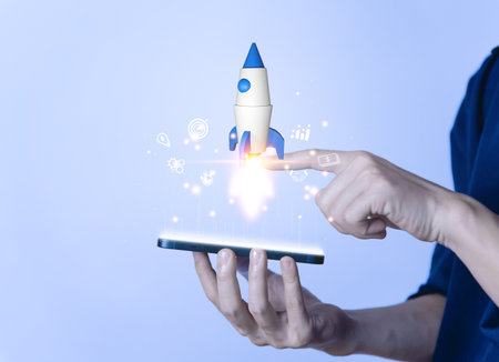 Businessman using smartphone showing rocket and icon Startup business concept Entrepreneurship concept and online digital business network connection on the interface Online Marketing, Technology andの写真素材