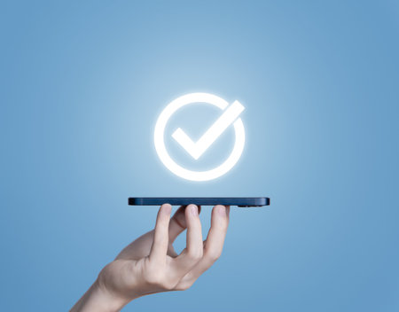 Hand holding smart phone showing best quality check mark icon Digital technology. warranty service concept Product Performance Guarantee and industry-leading ISO certifications.の写真素材