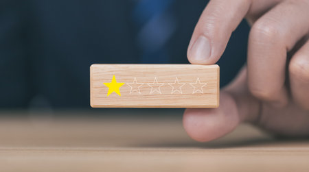 Customer review experience Dissatisfied Choosing 1 star review on wooden block, Negative concept about unhappy businessman, poor service or poor quality.の写真素材