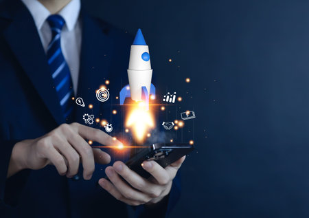hand shows a rocket and an icon. Concept of Startup Business, Entrepreneurship Idea, and Online...
