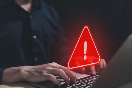 Businessman using laptop showing warning triangle and exclamation sign icon Warning of dangerous problems Server error. Virus. Maintenance concept. caution internet technology network securityの写真素材