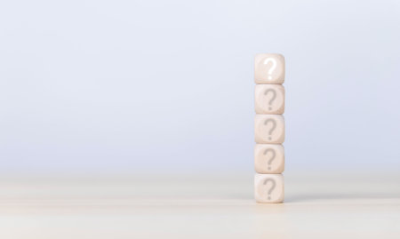 The wooden cube block shows a question mark icon. The concept of choice. Confusion. Business solution. copy spaceの写真素材
