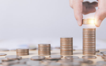 Businessman putting coins. Financial concept of bank account savings and investments to maximize profits. business investments for future growth and successの写真素材