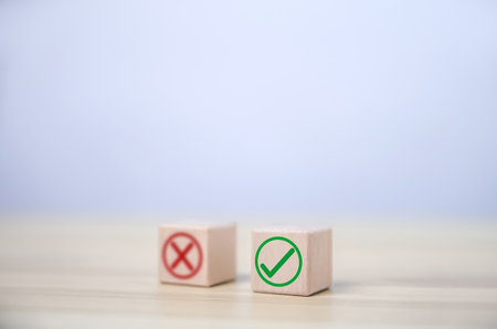 wooden block showing right and wrong sign decision concept, vote and think yes or no Business options for difficult situations true and false symbolの写真素材
