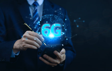 businessman holding a smartphone with hologram 6G digital technology, access to information around the world. 6G wireless internet network concept or IOT, high-speed communication connection.の写真素材