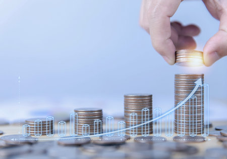 hand putting coins and charts. Financial concept of bank account savings and investments to maximize...