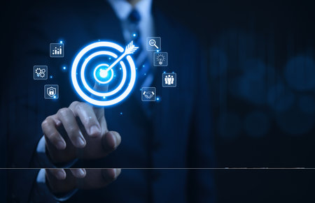 Businessman showing target arrow virtual digital technology icon on board, business investment concept, objectives and goals Marketing strategies and goals for successの写真素材