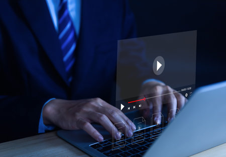 businessman using a laptop computer to watch live streaming online on a virtual monitor, connection technology concept Digital multimedia player, Internet video content, movie entertainment businessの写真素材