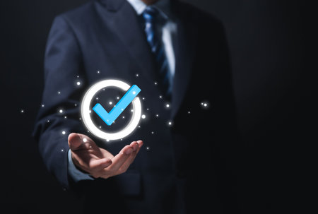 Businessman hand showing check mark digital technology icon symbol. Top quality assurance service concept, product performance assurance, and industry-leading ISO certification.の写真素材