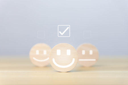 wooden block showing a smiley icon. customer concepts, satisfaction surveys, positive feedback The best response service from product user experience.の写真素材
