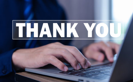 businessman touches the laptop and sends message words to thank you. Letter writing concept. congratulation, appreciation, and gratitude. with Copy Spaceの写真素材