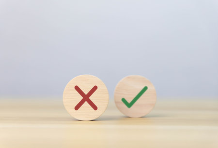 wood block showing right and wrong sign decision concept, vote and think yes or no Business options for difficult situations true and false symbol. select the right markの写真素材