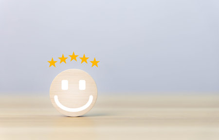 wooden block showing a smiley icon and five stars. customer concepts, satisfaction surveys, positive...