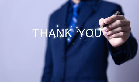 businessman touches the laptop and sends message words to thank you. Letter writing concept. congratulation, appreciation, and gratitude. with Copy Spaceの写真素材
