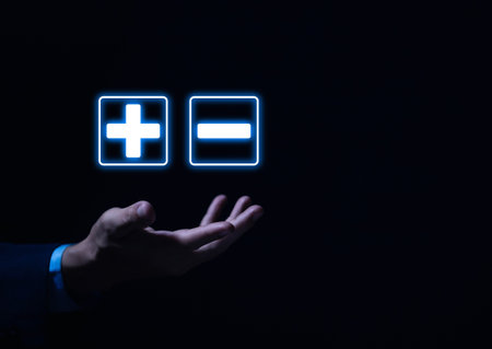 hand show plus and minus signs. Concept of opposites, decisions, and uncertainty. Positive or Negative Business Choices Analysis of advantages and disadvantages Comparisonの写真素材