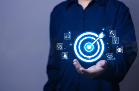 Businessman showing target arrow virtual digital technology icon on board, business investment concept, objectives and goals Marketing strategies and goals for successの写真素材