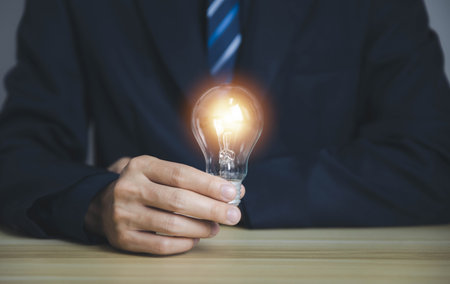 businessman holding a light bulb Digital technology. imagine an idea Creative and innovative. brain to brainstorm ideas in business. Strategies for development, growth, and successの写真素材