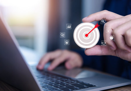 Businessman showing target arrow virtual digital technology icon on board, business investment concept, objectives and goals Marketing strategies and goals for successの写真素材