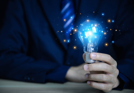 businessman holding a light bulb Digital technology. imagine an idea Creative and innovative. brain to brainstorm ideas in business. Strategies for development, growth, and successの写真素材