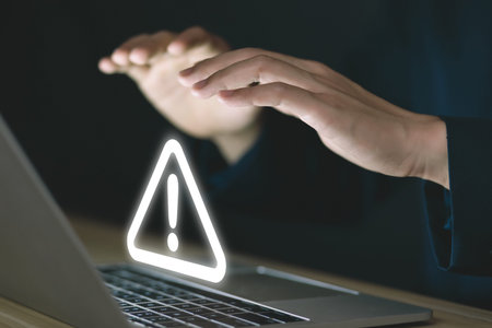 Businessman using laptop showing warning triangle and exclamation sign icon Warning of dangerous problems Server error. Virus. Maintenance concept. caution internet technology network securityの写真素材