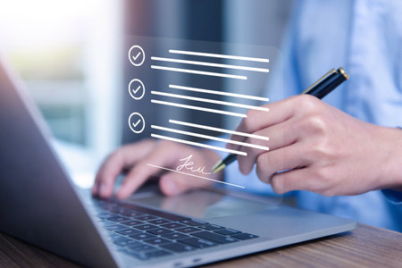 Businessman signing the electronic contract on virtual laptop screen via the internet Information concept of the digital technology document business, smart contract, corporate paperless office.の写真素材