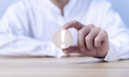 wooden block showing an exclamation mark. business development ideas Error warning, notification, maintenance and finding solutions with copy spaceの写真素材