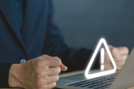 Businessman using laptop showing warning triangle and exclamation sign icon Warning of dangerous problems Server error. Virus. Maintenance concept. caution internet technology network securityの写真素材