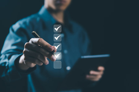 the person holding a tablet ticks the checkmark in the box. on the list of documents. the concept of check form online, checklist process order. business verify task detail and evaluation tick markの写真素材