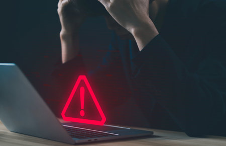 laptop shows a warning sign of system failure. concept notification a spam, risk of website technology digital online. caution danger if a computer is attacked cyber error symbol, leak software dataの写真素材
