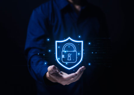 Businessman hand showing shield icon with lock sign Computer password protection concept, internet...