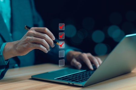 person ticks the checkmark in the box on the laptop. business verify task detail and evaluation tick mark, concept audit, check form online, on the list of documents, checklist process order.の写真素材