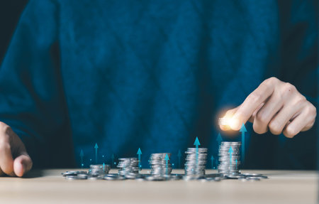 hand holding coin has an increase graph. concept of financial save money and index fund growth investment, income pension. profit fund high up in the stock market, business success in the futureの写真素材