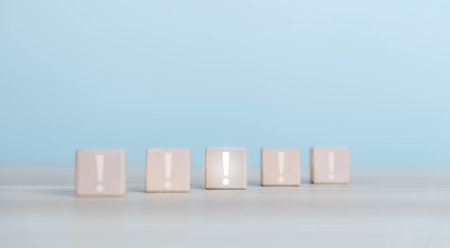 wood block shows an icon exclamation mark. points attention. concept of signal alert, caution, or idea. information important in business and securityの写真素材