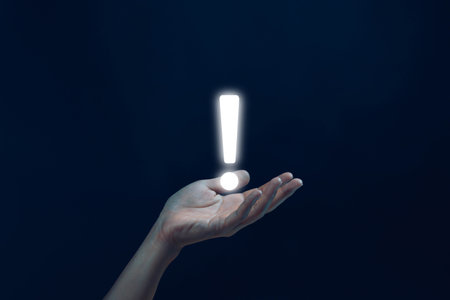 hand shows an icon exclamation mark. information important in business and security. concept of signal alert points attention, caution, or ideaの写真素材