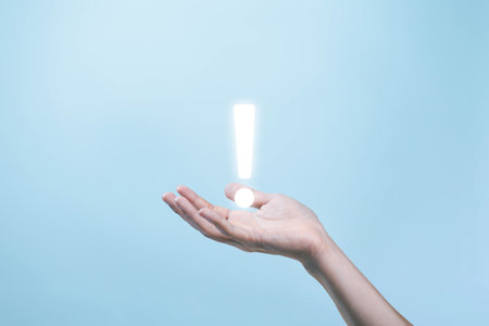 hand shows an icon exclamation mark. information important in business and security. concept of signal alert points attention, caution, or ideaの写真素材