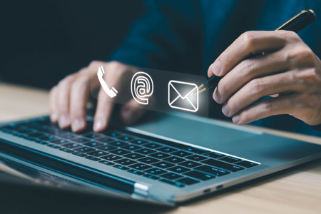 businessman using a laptop to contact customer support shows a contact icon ( address, phone, email,...