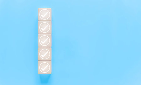 ticks the checkmark in the box on a wood block. list of documents. concept of audit, check form online, checklist process order. business verify task detail and evaluation tick markの写真素材