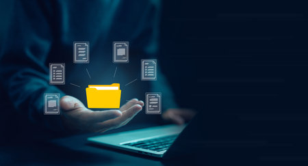 manages document data on a laptop. The concept of document files is digital electronic, business...
