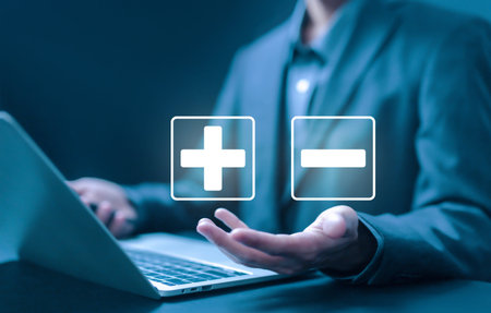 hand shows icon plus and minus, sign opposite negative positive. concept of comparing pros and cons, the decision to choose plus vs minus, versus good and badの写真素材