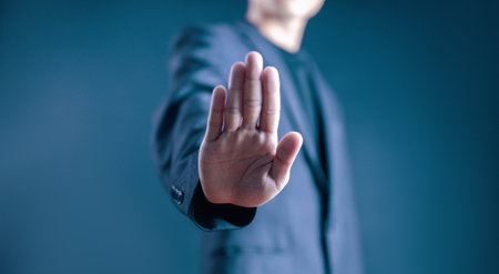 person's hand showing palm gestures stop, concept violence, warning, refuse, defense, caution. the hand sign of men a stopの写真素材