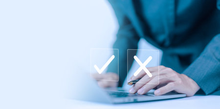 check right and wrong marks for business options on a laptop. yes or no decisions concept.  decide to choose to vote, difficult situations, symbols true and false, dilemmaの写真素材