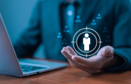 Business targeting concept with customer focus icon in hand, symbolizing audience segmentation, marketing strategy, and client analysis. Human Resource Management, HR Digital Business.の写真素材
