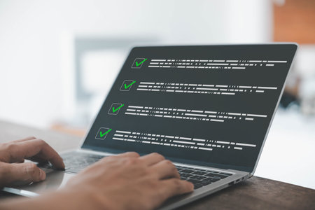 Checklist on laptop screen showing completed tasks with green check marks, symbolizing productivity, project management, workflow efficiency, organization, and goal achievement in business.の写真素材