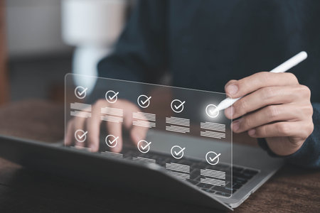 Businessman using digital checklist interface on laptop for task management and productivity tracking, modern technology concept in project planning and organization. checklist item, verify documentの写真素材