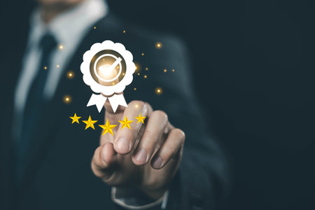 Businessman touching virtual quality award badge with five-star rating, symbolizing customer satisfaction, service excellence, brand trust, and high-quality business standards. quality controlの写真素材